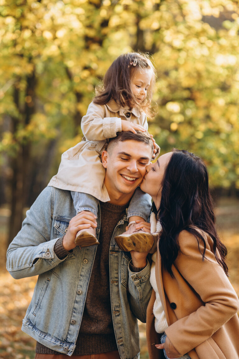 Young Family With Child On Shoulders Protected By Life Insurance